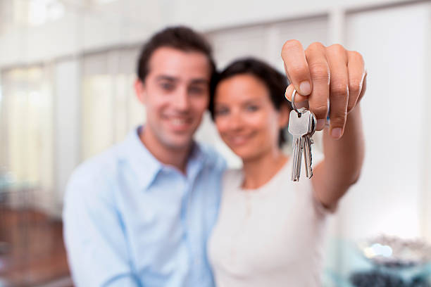 happy-smiling-young-couple-showing-keys-of-their-new-house-picture-id180301601-k-6-amp;m-180301601-amp;s-612x612-amp;w-0-amp;h-0l9b8FJLhbJsw1R4QwEQiTwxF0vKuzqHqQjDvk72dmg-.jpg